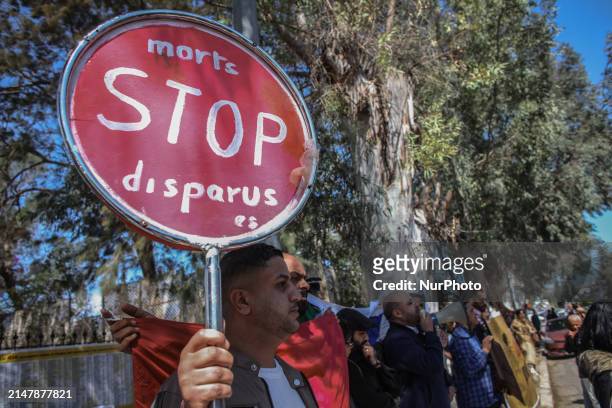 Demonstrator is raising a placard that reads in French, ''Dead and Missing Stop,'' during a demonstration on the occasion of Italian Prime Minister...