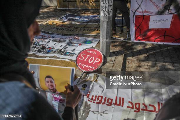 Placard is lying on the ground, reading in French, ''Dead, missing, Stop,'' during a demonstration in front of the Italian Embassy in Tunis, Tunisia,...