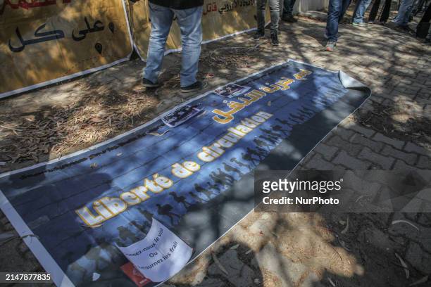 Banner is lying on the ground, reading in Arabic, ''freedom of movement,'' during a demonstration in front of the Italian Embassy in Tunis, Tunisia,...