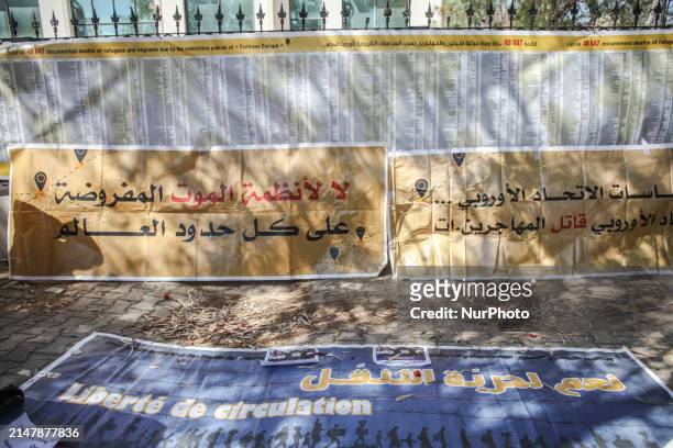 Banners are being displayed in front of the Italian Embassy in Tunis, Tunisia, on April 17 during a demonstration coinciding with the visit of...