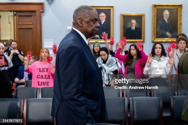 Protesters from the group Code Pink stand as U.S. Secretary of Defense Lloyd Austin arrives for a House Appropriations Committee hearing on Capitol...