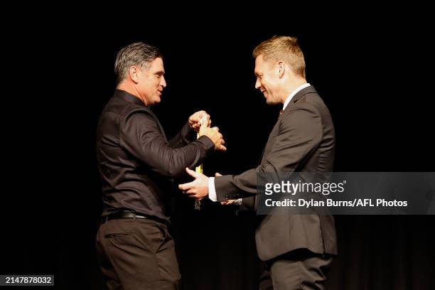 Shane Crawford, Hawthorn FC Hall of Fame Inductee presents a medal to Sam Mitchell, Hawthorn FC Hall of Fame Inductee and current Senior Coach during...