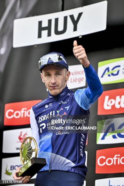 Britain's Stephen Williams of Israel-Premier Tech celebrates victory on the podium after the men's race of the 'La Fleche Wallonne', one day cycling...