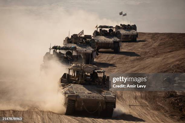 Israeli armored personnel carriers move along the border after leaving the Gaza Strip on April 17, 2024 in Southern Israel. Israel's allies,...