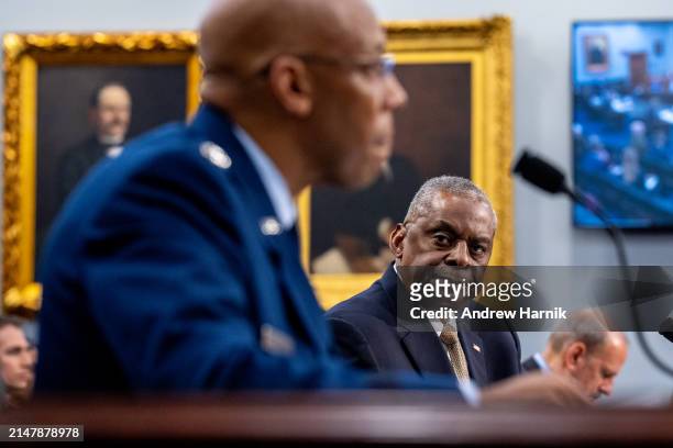 Secretary of Defense Lloyd Austin , accompanied by Department of Defense Comptroller Michael McCord , listens as Chairman of the Joint Chiefs of...