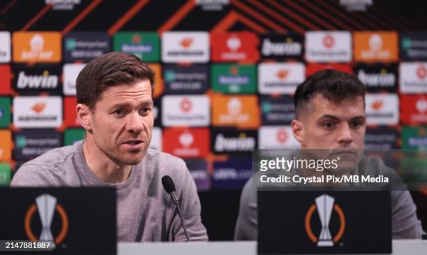 Xabi Alonso, Manager of Bayer 04 Leverkusen and Granit Xhaka of Bayer 04 Leverkusen during the pre match press conference ahead of their UEFA Europa...