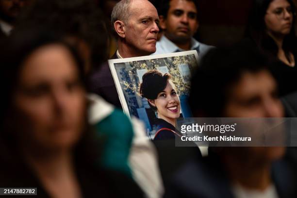 Chris Moore holds up a photograph of their daughter Danielle Moore, who died after Ethiopian Airlines flight 302 crashed minutes after it took off...