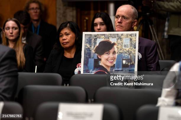 Clariss Moore and Chris Moore hold up a photograph of their daughter Danielle Moore, who died after Ethiopian Airlines flight 302 crashed minutes...