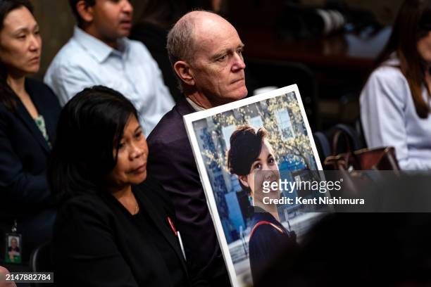 Clariss Moore and Chris Moore hold up a photograph of their daughter Danielle Moore, who died after Ethiopian Airlines flight 302 crashed minutes...