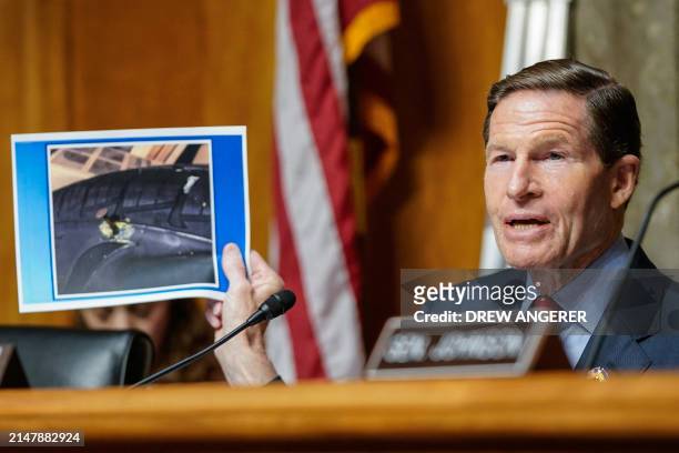 Committee Chairman, US Senator Richard Blumenthal, Democrat of Connecticut, holds a picture of a nail in a tire that Boeing engineer, Sam Salehpour...