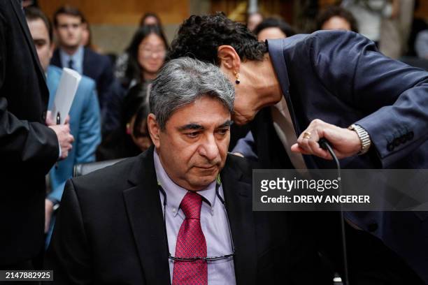 Boeing engineer, Sam Salehpour listens to a woman during a US Senate Homeland Security and Governmental Affairs Subcommittee on Investigations during...