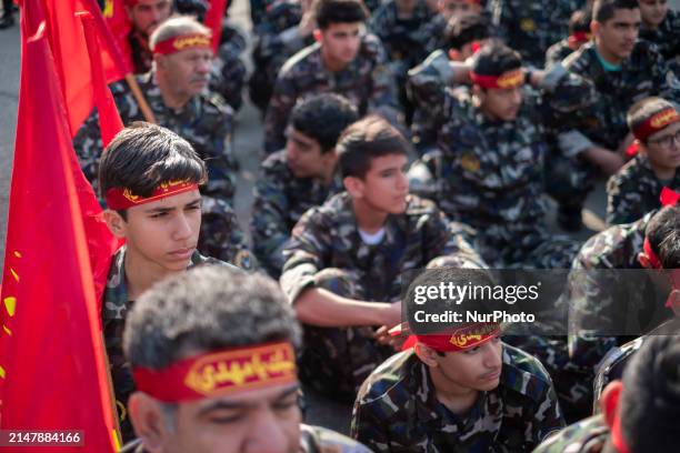 Members of the Basij paramilitary force are preparing to march in a military parade marking Iran's Army Day anniversary at an Army military base in...