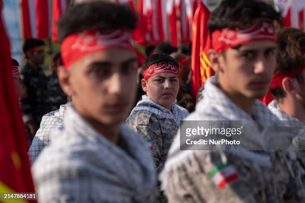 Iranian schoolboys, who are also members of the Basij paramilitary force, are preparing to march in a military parade marking Iran's Army Day...