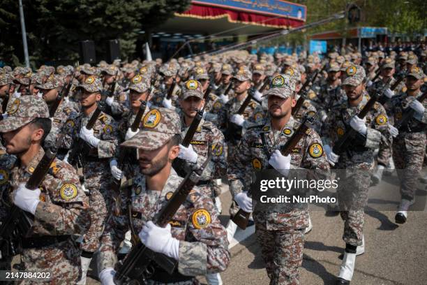 Members of the Iranian Army's land force are marching in a military parade to mark the anniversary of Iran's Army Day at an Army military base in...