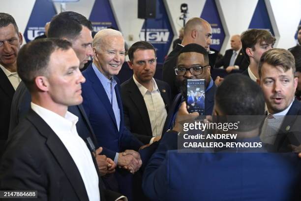 President Joe Biden takes pictures with guests during an event at the United Steelworkers Headquarters in Pittsburgh, Pennsylvania, on April 17,...