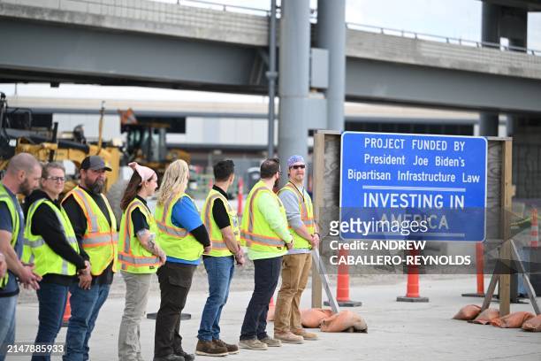 Construction workers await the arrival of US President Joe Biden at a modernization project at Pittsburgh International Airport in Pittsburgh,...