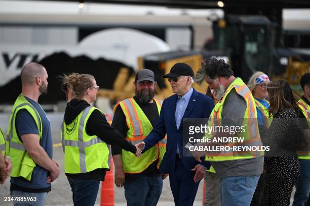 President Joe Biden greets construction workers at a modernization project at Pittsburgh International Airport in Pittsburgh, Pennsylvania, on April...