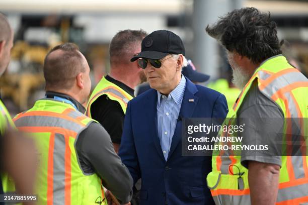 President Joe Biden greets construction workers at a modernization project at Pittsburgh International Airport in Pittsburgh, Pennsylvania, on April...