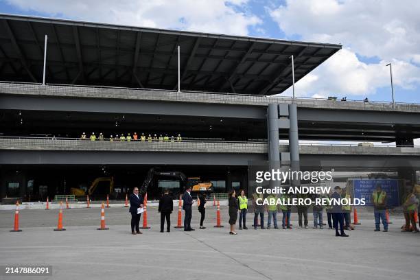 President Joe Biden speaks with construction workers at a modernization project at Pittsburgh International Airport in Pittsburgh, Pennsylvania, on...