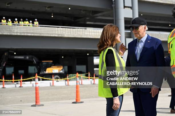 President Joe Biden speaks with a construction worker at a modernization project at Pittsburgh International Airport in Pittsburgh, Pennsylvania, on...