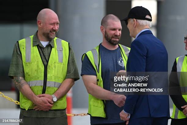 President Joe Biden speaks with construction workers at a modernization project at Pittsburgh International Airport in Pittsburgh, Pennsylvania, on...