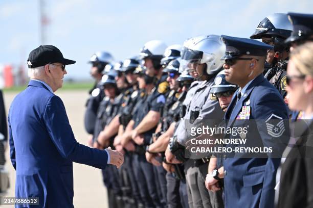 President Joe Biden greets law enforcemnt officer before boarding Air Force One at Pittsburgh International Airport in Pittsburgh, Pennsylvania, on...