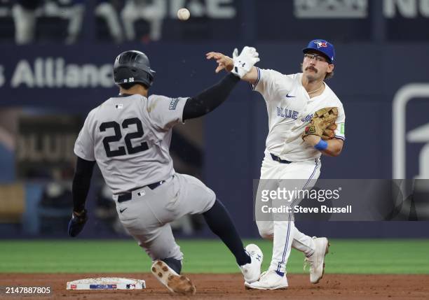 Toronto Blue Jays outfielder Davis Schneider turns a double play as New York Yankees outfielder Juan Soto slides in as the Toronto Blue Jays play the...