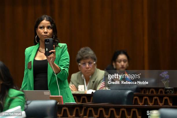 Arizona State Rep. Analise Ortiz films her Republican colleagues during a legislative session at the Arizona House of Representatives on April 17,...