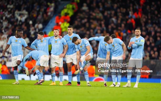 Manchester City players look on during the penalty shootout following the UEFA Champions League quarter-final, second leg match at the Etihad...