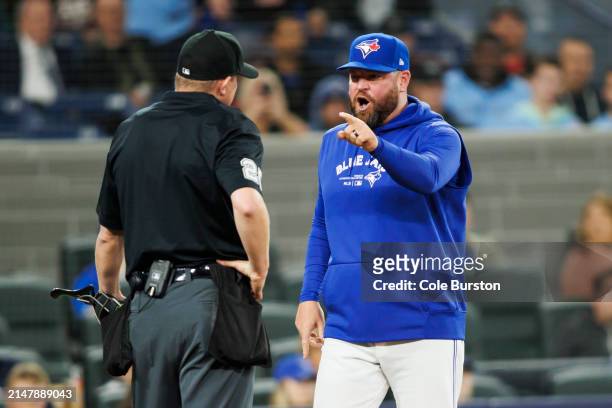 John Schneider, manager of the Toronto Blue Jays yells at umpire Tom Hallion in the ninth inning of their MLB game against the New York Yankees at...
