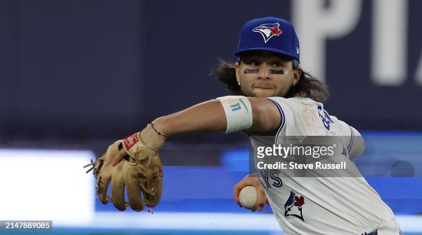 Toronto Blue Jays shortstop Bo Bichette looks to throw as the Toronto Blue Jays play the New York Yankees at Rogers Centre in Toronto. April 17,...