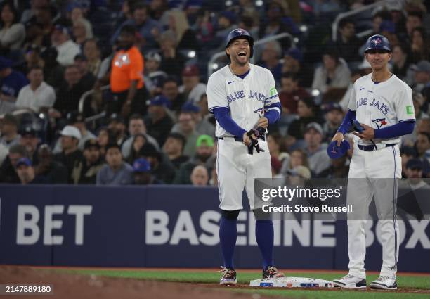 Toronto Blue Jays outfielder George Springer laughs after getting a single as the Toronto Blue Jays play the New York Yankees at Rogers Centre in...