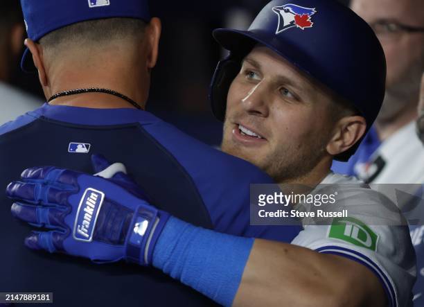Toronto Blue Jays outfielder Daulton Varsho gets a hug after hitting his second home run of the game as the Toronto Blue Jays play the New York...