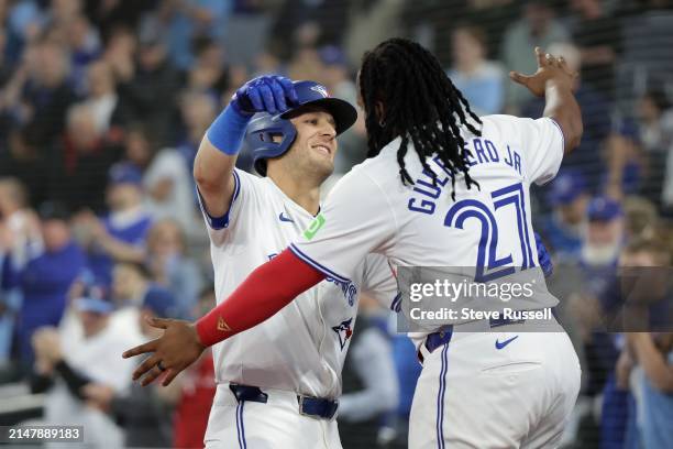 Toronto Blue Jays outfielder Daulton Varsho gets a hug from Toronto Blue Jays first base Vladimir Guerrero Jr. After hitting his second home run of...