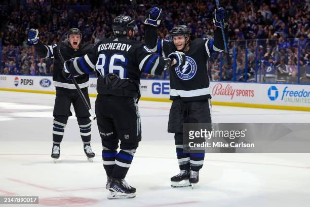 Nikita Kucherov of the Tampa Bay Lightning celebrates his 100th assist on the season with Brayden Point, right, against the Toronto Maple Leafs...