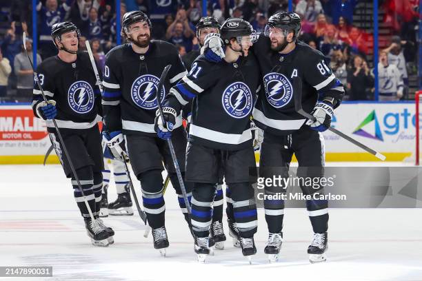 Nikita Kucherov of the Tampa Bay Lightning, right, celebrates his 100th assist on the season with Brayden Point against the Toronto Maple Leafs...