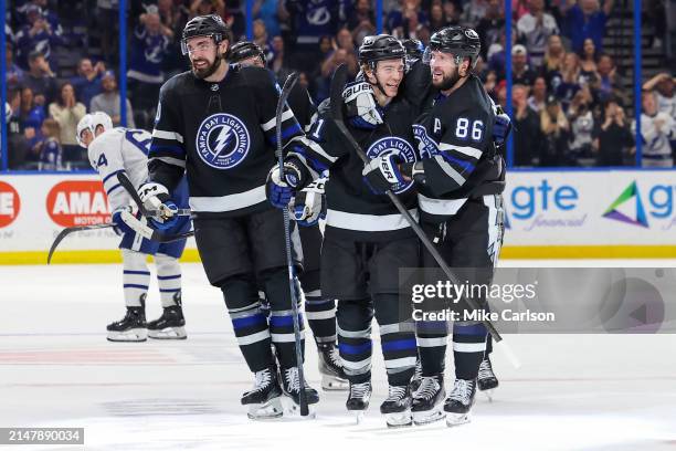 Nikita Kucherov of the Tampa Bay Lightning, right, celebrates his 100th assist on the season with Brayden Point against the Toronto Maple Leafs...