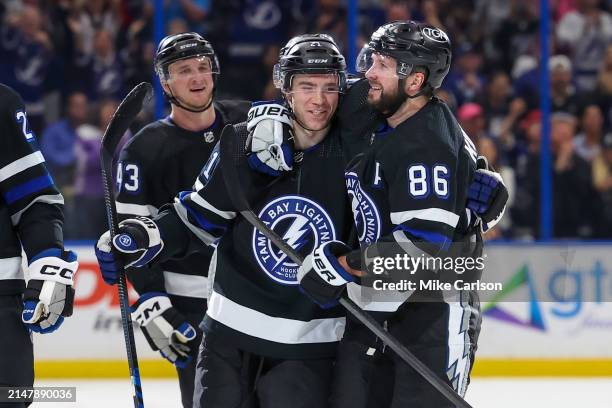 Nikita Kucherov of the Tampa Bay Lightning, right, celebrates his 100th assist on the season with Brayden Point against the Toronto Maple Leafs...