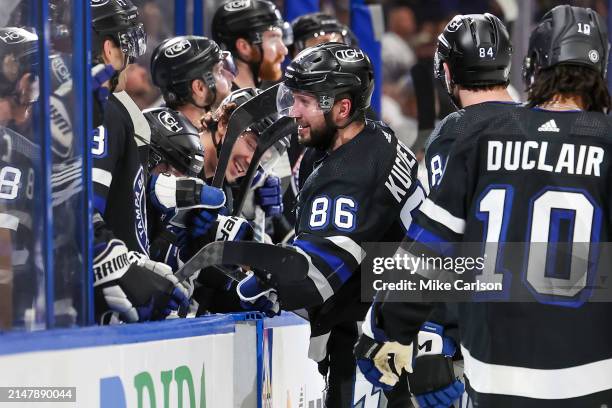 Nikita Kucherov of the Tampa Bay Lightning, right, celebrates his 100th assist on the season against the Toronto Maple Leafs during the second period...