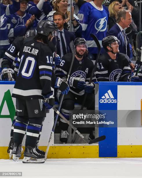 Nikita Kucherov of the Tampa Bay Lightning celebrates his 100th assist on the season with teammates against the Toronto Maple Leafs during the second...