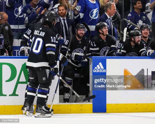 Nikita Kucherov of the Tampa Bay Lightning celebrates his 100th assist on the season with teammates against the Toronto Maple Leafs during the second...