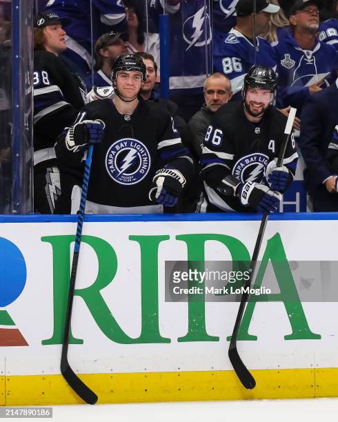 Nikita Kucherov and Brayden Point of the Tampa Bay Lightning celebrate a goal by teammate Brandon Hagel against the Toronto Maple Leafs during the...