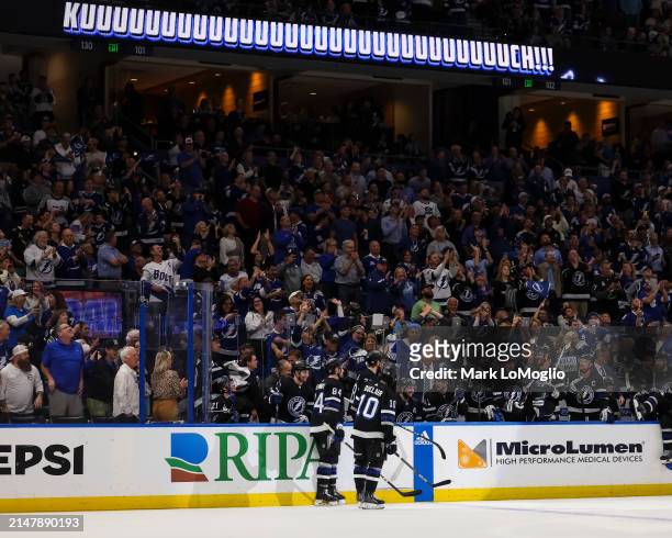 Nikita Kucherov of the Tampa Bay Lightning celebrates his 100th assist on the season with teammates against the Toronto Maple Leafs during the second...