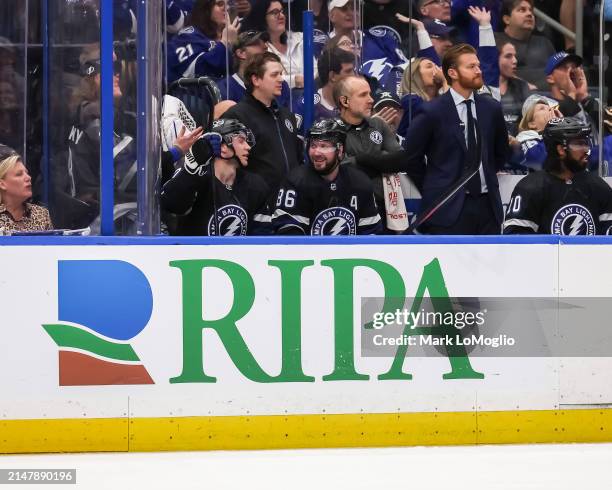 Nikita Kucherov of the Tampa Bay Lightning celebrates his 100th assist on the season with teammates against the Toronto Maple Leafs during the second...