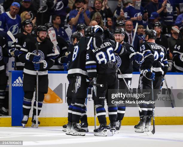 Nikita Kucherov of the Tampa Bay Lightning celebrates his 100th assist on the season with teammates against the Toronto Maple Leafs during the second...