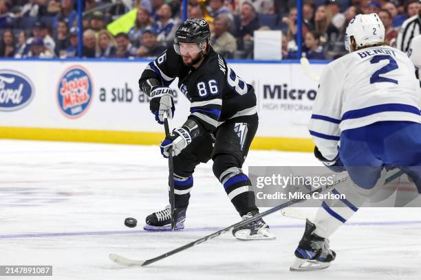 Nikita Kucherov of the Tampa Bay Lightning passes against Simon Benoit of the Toronto Maple Leafs during the second period at the Amalie Arena on...