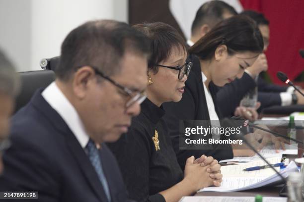 Retno Marsudi, Indonesia's foreign affairs minister, center, speaks with Wang Yi, China's foreign minister, not photographed, during a bilateral...