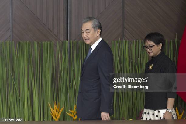 Wang Yi, China's foreign minister, left, and Retno Marsudi, Indonesia's foreign affairs minister, arrive for a bilateral meeting in Jakarta,...