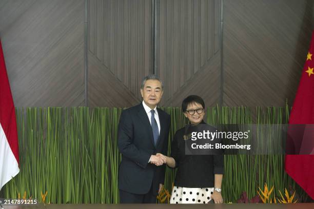 Wang Yi, China's foreign minister, left, and Retno Marsudi, Indonesia's foreign affairs minister, pose for photographs in Jakarta, Indonesia, on...