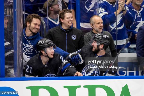 Nikita Kucherov of the Tampa Bay Lightning celebrates his 100th assist on the season with teammate Mikhail Sergachev against the Toronto Maple Leafs...